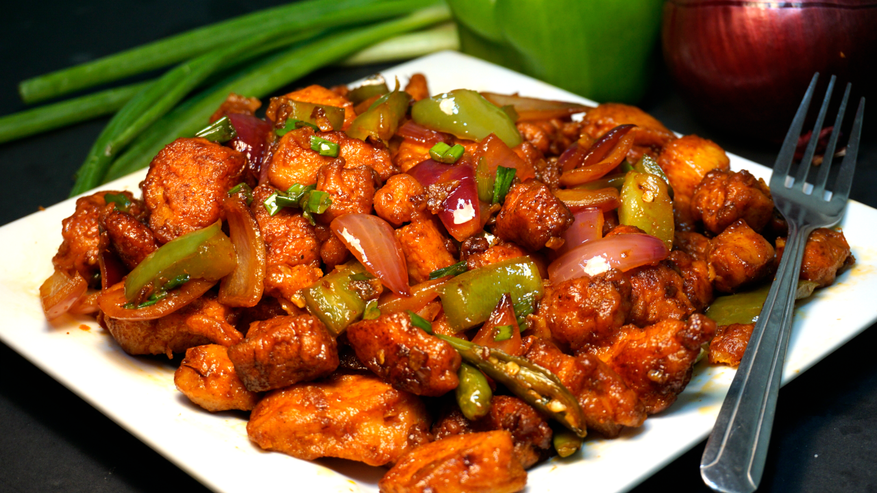 Boneless chicken pieces stir-fried with dry whole chili, hot spices and oni...